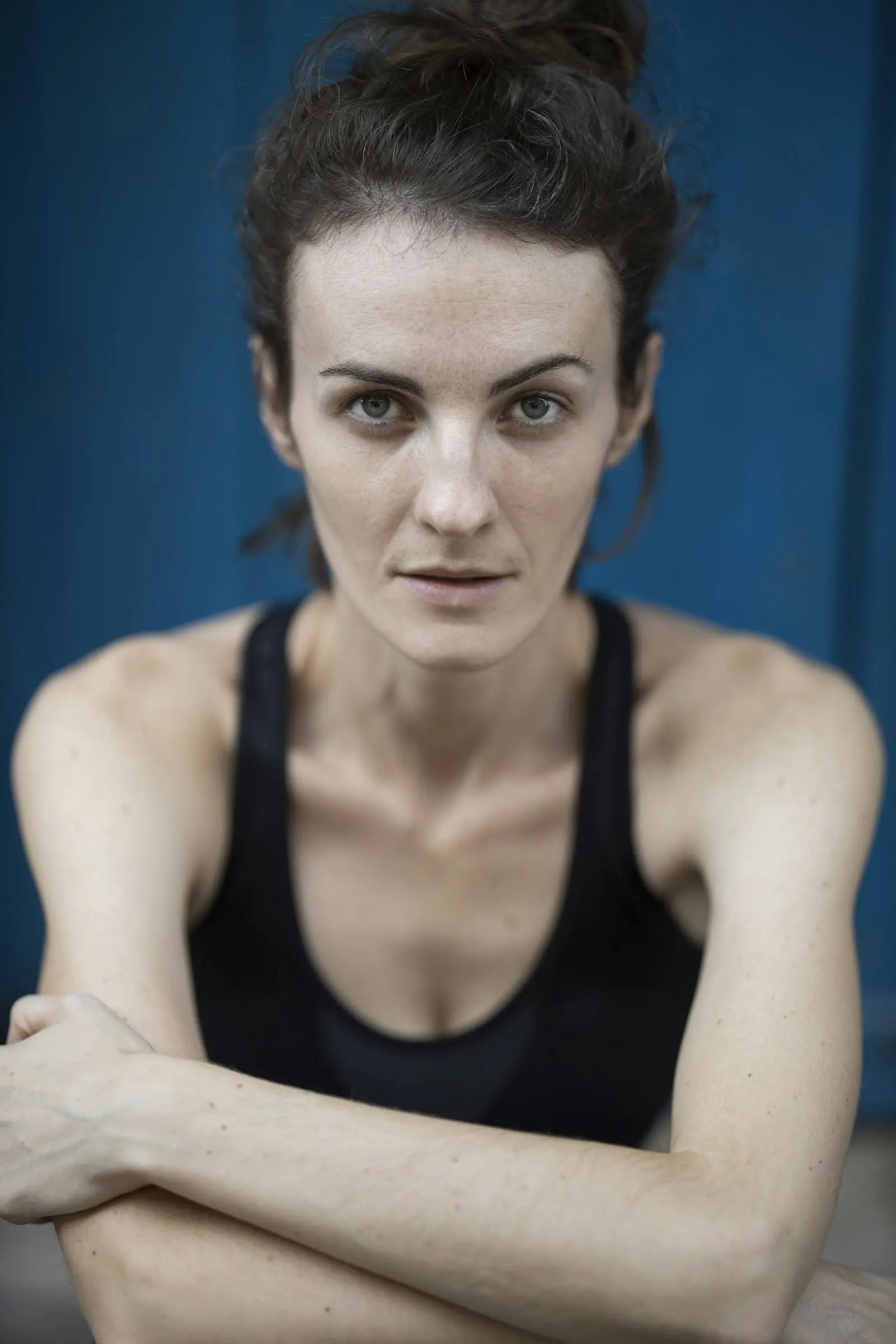 Portrait of Maya, a calm woman in a black top, soft daylight, warm and approachable
